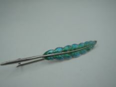 A silver and enamel brooch modelled as a feather in shades of green and turquoise, Chester 1911,