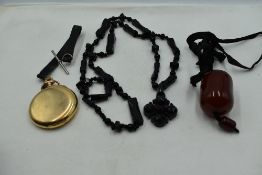 A string of carved jet mourning beads with Cross pendant, a gold plated hunter pocket watch by