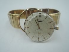 A gent's 9ct gold Longines wrist watch having a baton numeral dial with subsidiary seconds in a