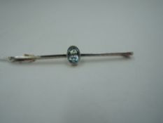 A yellow metal bar brooch stamped 9ct having central blue paste oval collared stone, approx 2.7g