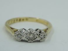 A diamond trilogy ring, total approx 0.15ct in an illusionary mount on an 18ct gold loop, size M &