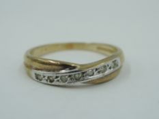 A 9ct gold band ring having diamond chip decoration to moulded cross detail, size P & approx 2.1g