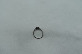 A white metal ring loop missing stone, approx 1.8g