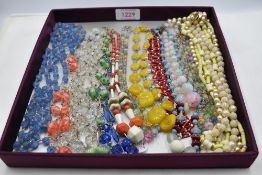 A selection of vintage bead necklaces including gold wire, woven, etc