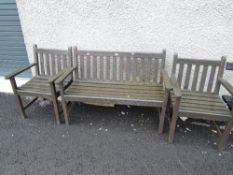 A wooden garden bench and two chairs