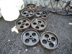 Seven heavy set cast iron railway or similar truck wheels