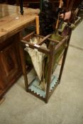An early 20th Century oak stick stand, including lacework parasol, cane handled umbrella, walking