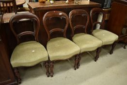 A set of four Victorian mahogany balloon back chairs having turned legs and later green dralon