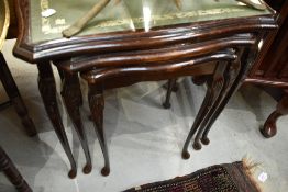 A period style nest of three tables having leather inserts and glass tops