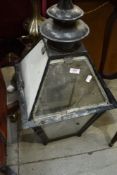 A traditional street lamp top, one glass pane damaged