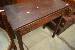 A 19th Century mahogany fold over tea table having single frieze drawer, in need of some