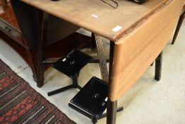 A vintage part stripped and dark stained Ercol drop leaf kitchen dining table