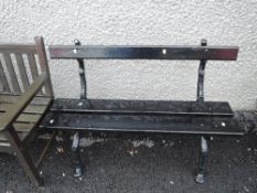 A vintage garden bench with cast iron wood styled frame