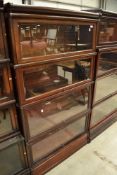 An early 20th Century mahogany and stained frame stacking bookcase unit base having four glazed