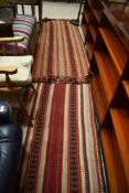 A pair of traditional rugs/runners in shades of orange , red and cream, native american style