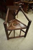 An interesting oak and unusual tricorn chair having carved back, solid seat and turned frame