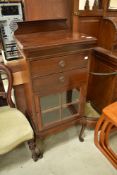 An early 20th Century mahogany music cabinet on cabriole legs