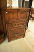 A late 20th Century old charm cocktail cabinet having linen fold design, width approx 75cm