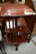 A reproduction mahogany revolving bookcase