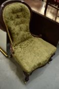 A Victorian mahogany low seat nursing or salon chair having knurl frame