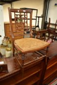 A Victorian mahogany salon or nursing chair having canework seat
