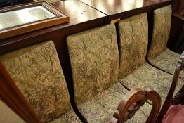 A set of four vintage dining chairs having medieval style upholstery