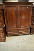 A period oak wardrobe or hallrobe having carved frieze with monogram and bearing date 1707, with two