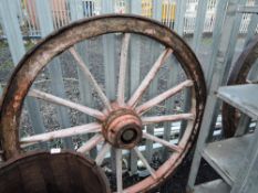 A pair of large wooden cart wheels