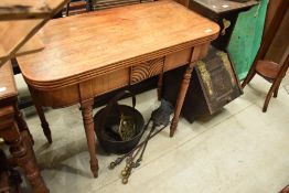 A 19th Century mahogany fold over tea table on turned legs