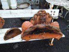 A selection of terracotta wall sconce and a lion head water fountain