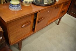 A mid Century part teak sideboard of stylised form , width approx. 167cm
