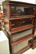 An early 20th Century mahogany and stained frame stacking bookcase unit base having four glazed