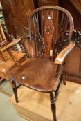 A traditional stained frame Windsor style wheel back kitchen chair having H stretcher