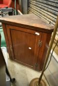 A 19th century oak corner cupboard of small proportions
