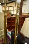 Two brass standard lamps of similar but not matching designs