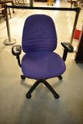A modern office armchair, purple upholstery