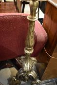 A traditional gilt wood frame standard lamp of foliate scroll design