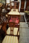 A set of four reproduction dark stained frame dining chairs