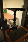 A Victorian style black painted snap top occasional table, having turned column and triple splay