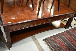 A reproduction coffee table in the Regency style, having highly polished finish and frieze drawers