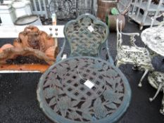 A vintage cast iron garden table and one chair