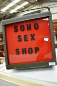 A vintage light , with red and black label for 'soho Sex Shop'