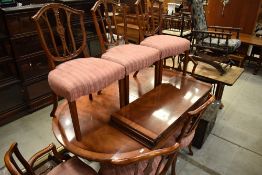 A reproduction Regency oval extending dining table ad set of eight (six plus two) chairs