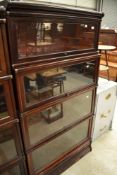 An early 20th Century mahogany and stained frame stacking bookcase unit base having four glazed