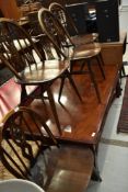 A set of four vintage dark stained Ercol kitchen chairs with fleur de lys style backs