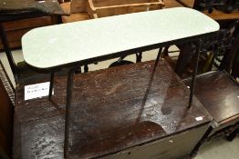 A vintage formica topped coffee table of slim design on metal legs