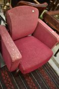 A vintage armchair on swivel base, semi recliner, on metal swivel base in moquette upholstery