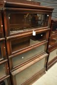 An early 20th Century oak stacking bookcase unit , having drawer base and four glazed tiers,
