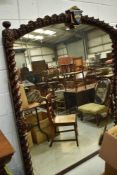 A 19th Century oak over mantel or grand hall mirror, having twist column and carved support ,
