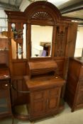 An impressive Victorian oak hall stand having fan design over mirror, and glove box with lift lid